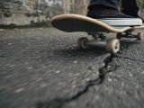 Dangerous Skateboarding: When a Road Crack Ends the Trick